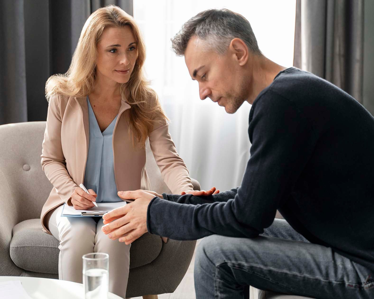 man sitting with a therapist in session