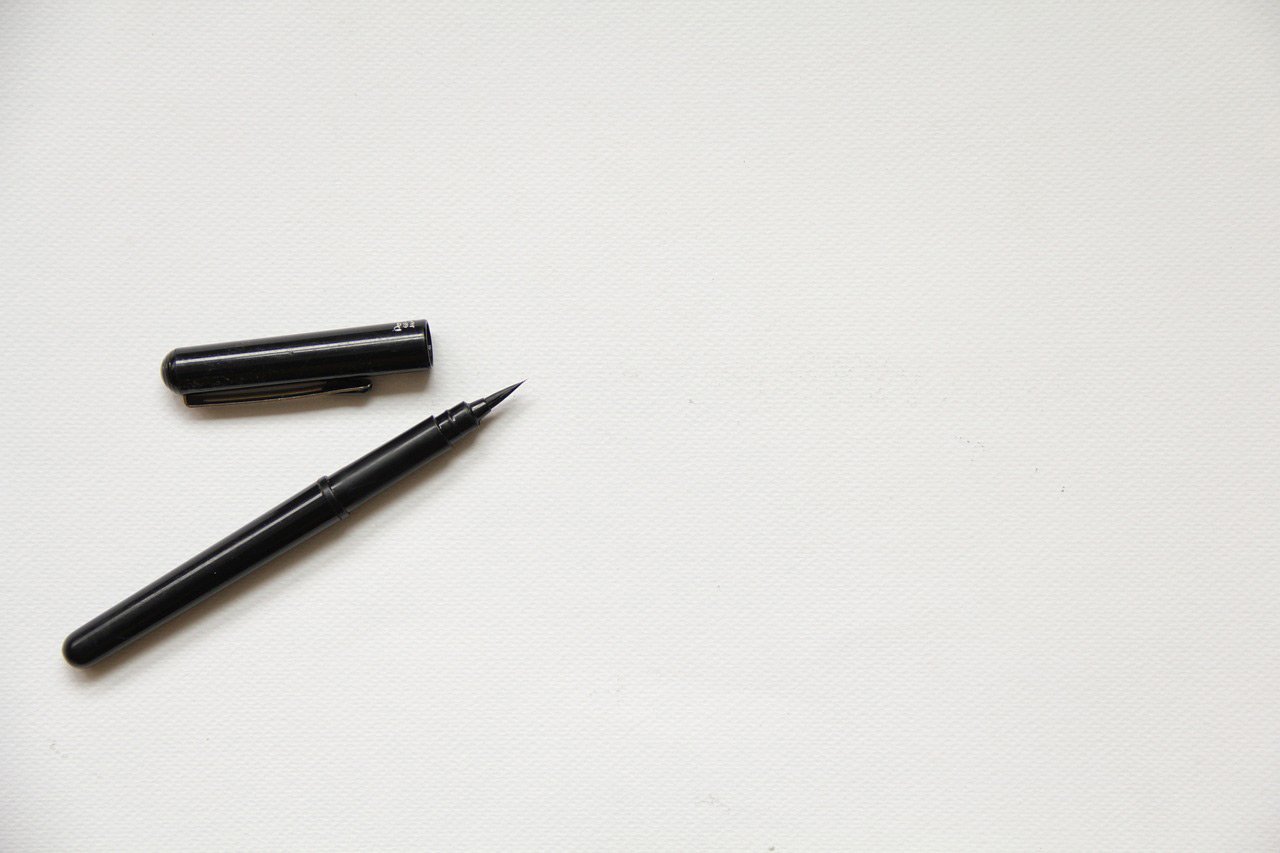 pen with lid off for writing referrals to the clinic