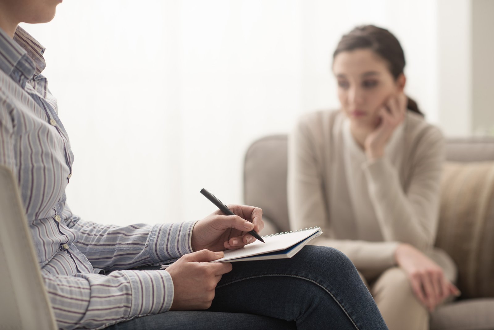 woman sitting in psychology session with her therapist